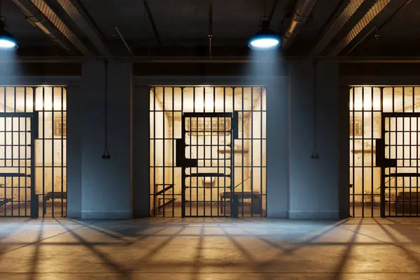 A view through the bars of the prisoner\'s cell doors, reveals a small room with a bed, small table, chair, and sink. The position of the observer is from the corridor outside the cell. Hallway