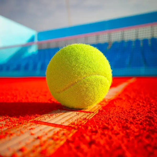 Close View Yellow Tennis Ball Lying Orange Court Net Background — Stock Photo, Image