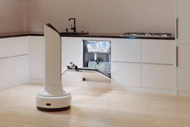Teknoloji harikası bir mutfak ortamında, sofistike bir robotik kol, bulaşık makinesini ustalıkla doldurarak ev otomasyonunun zirvesini gösterir..