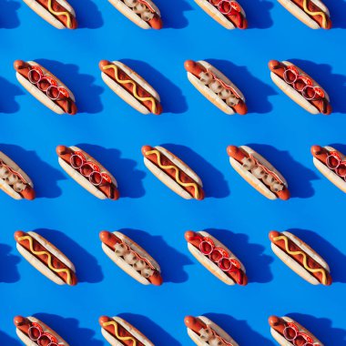 A meticulously arranged, seamless pattern of delectable hot dogs dressed with mustard and ketchup, vividly laid out over a bright blue backdrop for a striking visual effect. clipart