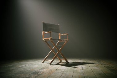 Yalnız bir yönetmenin sandalyesi, sahne ışıklarının altında, beklenti atmosferiyle, tiyatro ve film yapımcılığının özünü çağrıştırıyor..