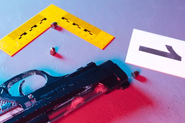 An extensive forensic crime scene layout captured from above, featuring a strategically dispersed array of evidence markers pinpointing bullets and a handgun amongst other crucial investigative items.