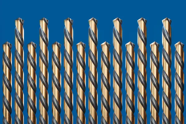 Meticulously Arranged Selection Golden Drill Bits Lay Striking Blue Surface — Stock Photo, Image