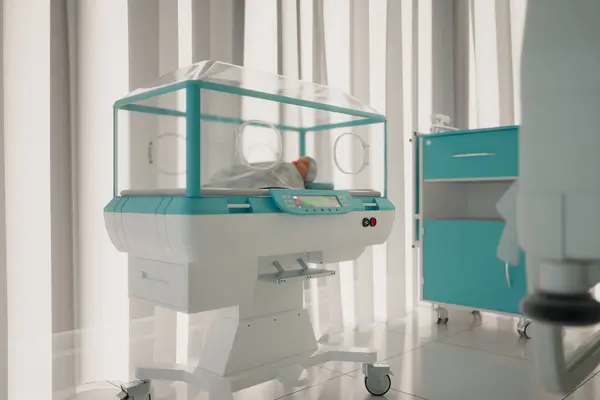 A sophisticated neonatal incubator stands ready in a hospital nursery, designed for the utmost care and protection of premature and at-risk newborns, ensuring their safety.