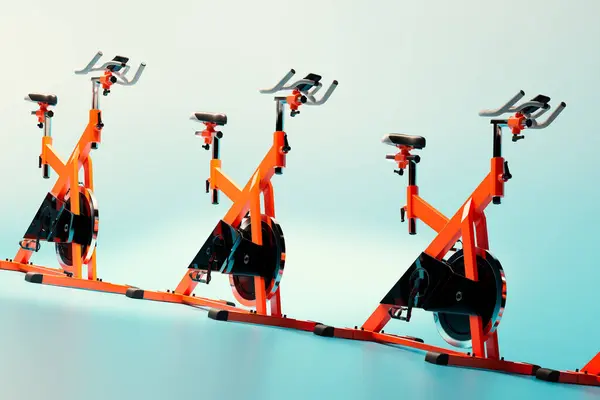 Trio Bright Orange Stationary Spin Bikes Stands Perfect Alignment Deep — Stock Photo, Image