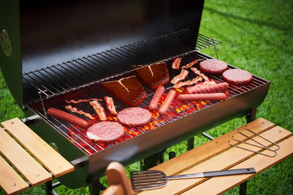 Multiple Meats Including Burgers Ribs Sausages Cook Flaming Charcoal Grill — Stock Photo, Image