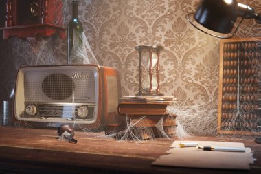 A captivating scene of a vintage radio, hourglass, and abacus veiled in cobwebs on a dusty desk, encapsulating a profound sense of time forgotten. clipart