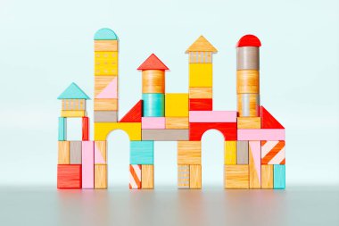 Bu büyüleyici görüntü parlak renkli ahşap bloklardan bir kule yakalıyor, geometrik şekillerin karışımını gösteriyor, yaratıcılığı ve eğitici oyunu vurguluyor.
