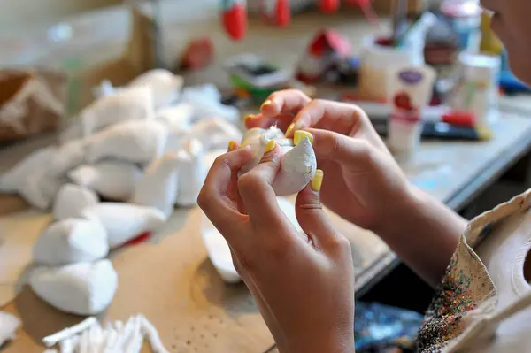 The process of making handmade christmas toys at the toy factory. DIY gift crafting. Handmade house decor. Home workshop