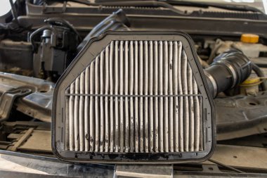Araba hava filtresi değişimi. Araba motorunda eski bir hava filtresi değiştirmek. Tamirci kirli hava filtresini değiştirip yeni filtre takıyor. Araç bakım servisi