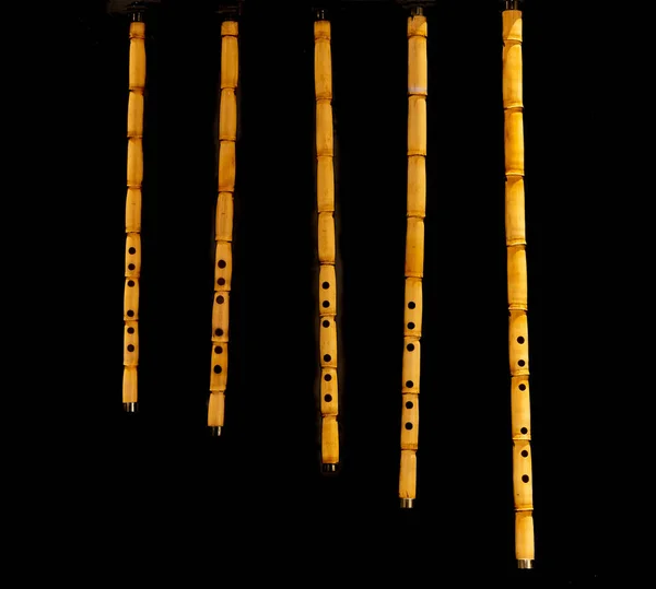 Bamboo flute or kaval. Wind instrument of various sizes. isolated on black background
