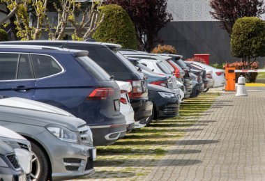 Arabalar açık bir otoparkta düzenli bir şekilde park edilir.