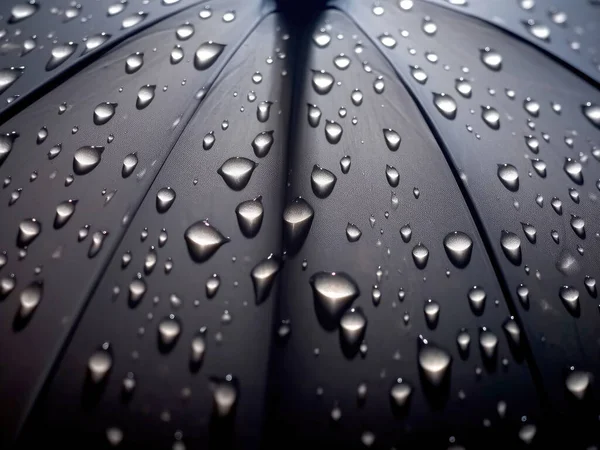 stock image Large raindrops on the surface of the umbrella. Close up