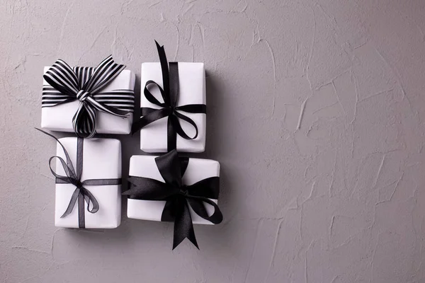 Set of wrapped boxes with presents on  grey textured background. Top view. Present concept. Place for text.
