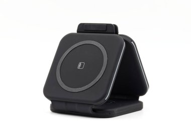 Foldable Wireless Charger isolated on white background. Wireless charging pad, mobile phones, smart watches, earphones. Charging device all in one concept.