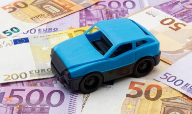 Blue model car isolated on Euro background. Costs of traveling concept.