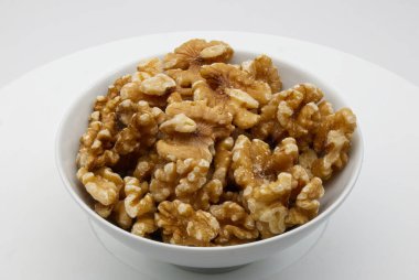 Walnut in a white bowl isolated on white background