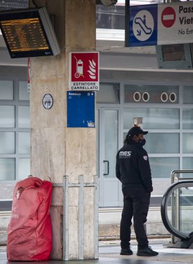Bologna - Italy - February 19, 2022: Security guard at the Bologna Centrale railway station.