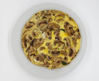 Omelette with mushrooms and cheese on white background. Top view.