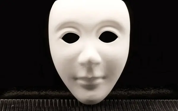 Human White face mask isolated on black background.