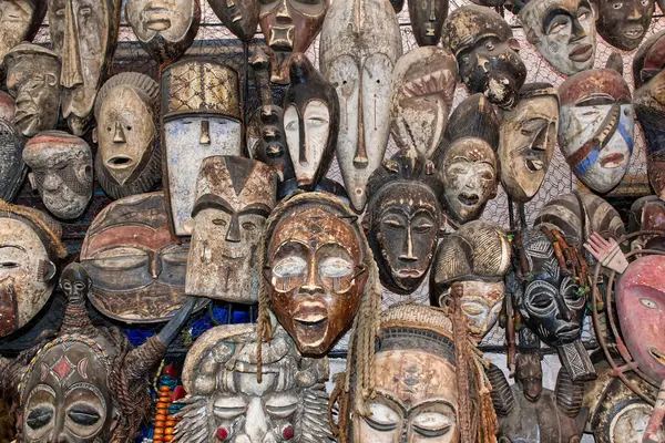 Tribal African masks displayed at a traditional Moroccan market, souk, in Marrakech. Morocco, Africa.
