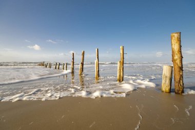 Breakwater - wooden posts on the North Sea beach on the Danish island of Romo - long exposure