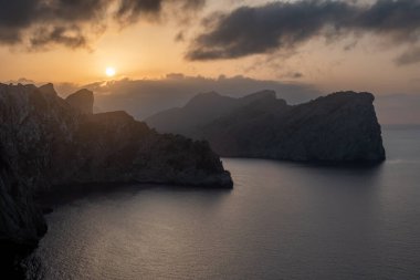 Formentor deniz fenerinden gün batımında Mallorca 'da dağlar ve deniz arasında
