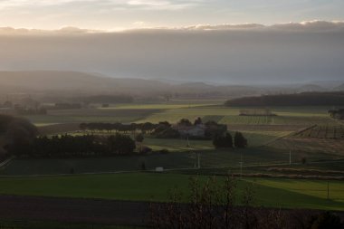 Lighting effect on plains at sunset in France in a small village la Begude de Mazenc
