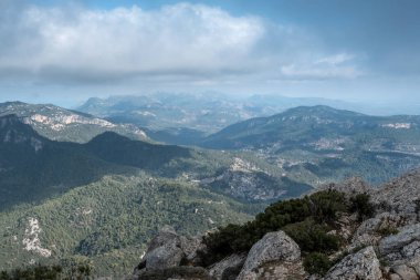 Vast mountain landscape in Mallorca with clouds and sun