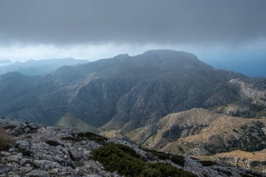 Exploring the mountains while hiking in Mallorca with cloudy sky