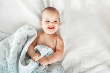 Baby 8 months on crib. Children's facial expressions, newborn care concept, sleep problems, healthy sleep, colic, teething