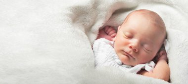 Newborn sleeping close up. Baby care concept. Web banner