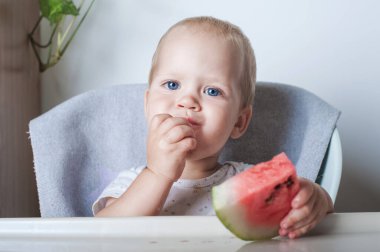 Yakışıklı çocuk, evde meyveli karpuz yiyor..