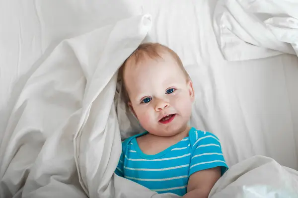 Baby 11 months old on the bed getting ready to sleep