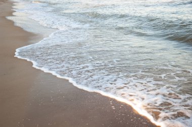 Kumda köpüklü deniz dalgası. Yaz mevsimi.