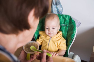 Mutlu Bebek Evde Büyükanne Tarafından Besleniyor.
