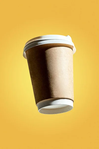 Poster with a levitating coffee paper cup. Creative mockup for a coffee shop. Yellow background
