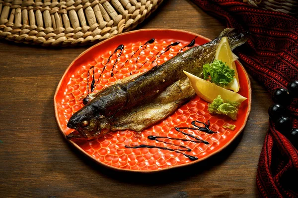 Fried river trout in a plate. Ukrainian cuisine