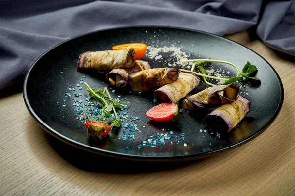 stock image Georgian dish - eggplant rolls with cheese, nuts and garlic in a plate