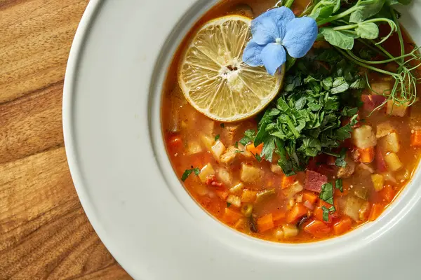 stock image Vegetarian tomato soup with various vegetables in a plate.