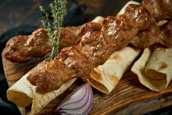 stock image Lamb Lyulya kebab with pita on wooden board. Turkish food