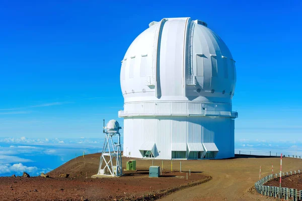 stock image Observatory unit placed at the summit of Mauna Kea, set against a clear blue sky.