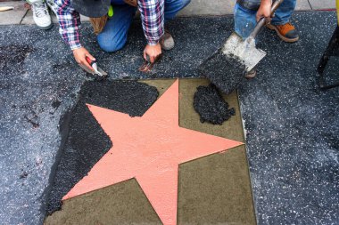 The process of placing a star on the Hollywood Walk of Fame in Los Angeles, California. clipart