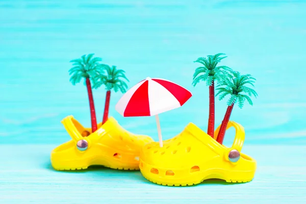 Close Pair Yellow Clog Shoes Toy Palm Trees Sun Umbrella — Stock Photo, Image