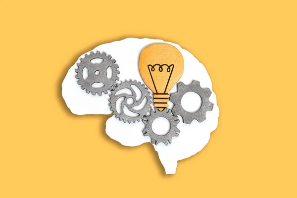 Close Human Brain Outline Wooden Gears Lightbulb Isolated Yellow Background — Stock Photo, Image