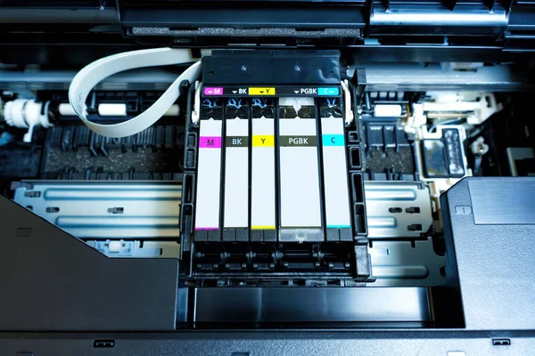 Detailed view of the inkjet printer carriage with freshly installed ink cartridges.