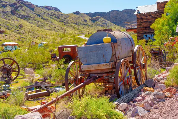 stock image Nelson, Nevada - April 15, 2024: Old-fashioned wooden water wagon sits quietly amidst the remnants of an abandoned town.