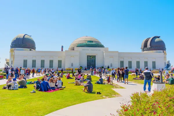 Stock image Los Angeles, California - April 8, 2024: People gather to observe a solar eclipse at Griffith Park, with the historic Griffith Observatory in the backdrop