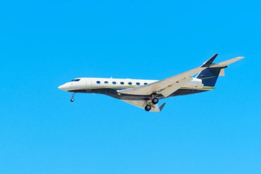 Los Angeles, California - 9 Nisan 2024: Açık mavi gökyüzüne vurgulanmış özel bir jetin yan perspektifi.