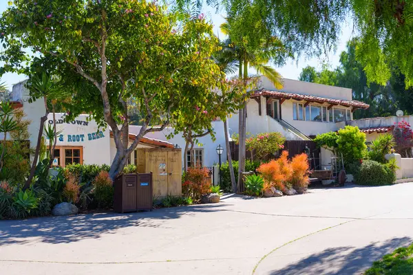 stock image San Diego, California - April 16, 2024: Shaded pathway lined with trees and plants in Old Town San Diego State Historic Park.